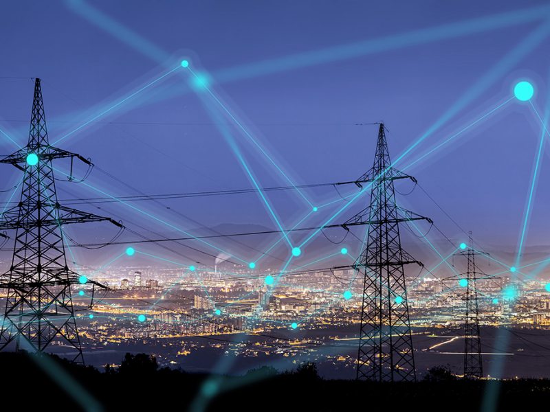 High power electricity poles in urban area connected to smart grid. Energy supply, distribution of energy, transmitting energy, energy transmission, high voltage supply concept photo.